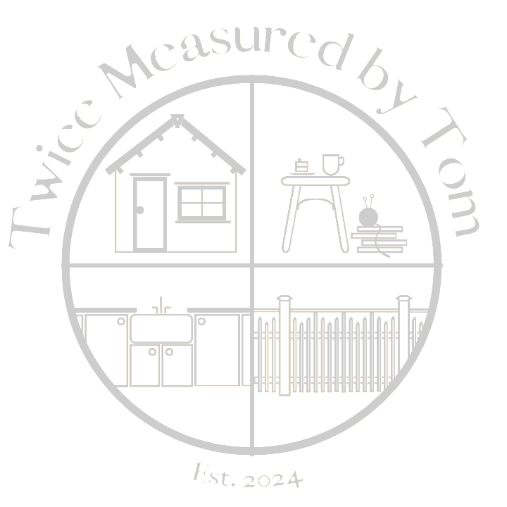 Company logo consisting of a circle with 4 quadrants with simple sketched images. From top left moving clockwise the quadrants contain:
1- a shed
2- a simple wooden stool with a cup of tea and piece of cake on top of it and a pile of books next to it. The books have a ball or yarn with two knitting needles protruding from the top.
3- a picket fence consisting of a solid top rail and then bays consisting of 3 scalloped shorter pickets between single longer pickets that reach all the way to the top rail
4- a butler style kitchen sink with built in cupboards below and to either side.
Above the circle is the company title "Twice Measured by Tom".
Below the circle it says "Est. 2024"